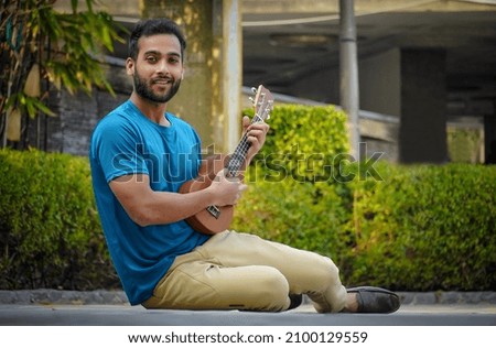 handsome young man woman playing ukulele