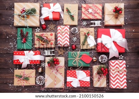 Gift box with ornaments on brown wooden background