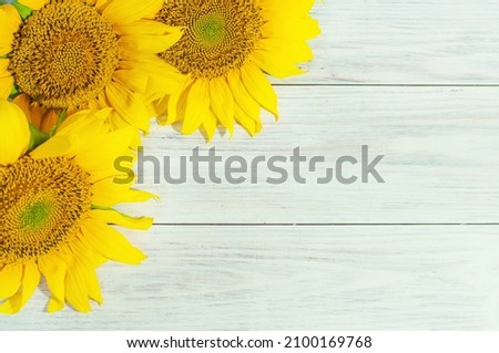 bouquet of yellow sunflowers on a light wooden background with space for text. High quality photo