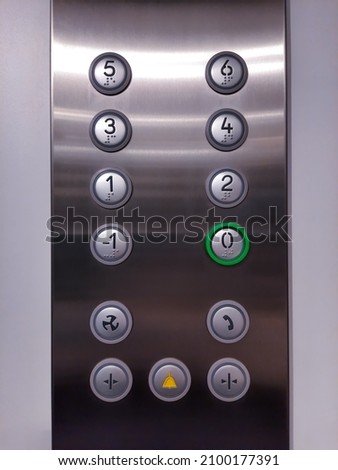Elevator lift buttons keypad. Push car operating panel, COP panel pressing. Calling the lift inside the cabin. Royalty-Free Stock Photo #2100177391