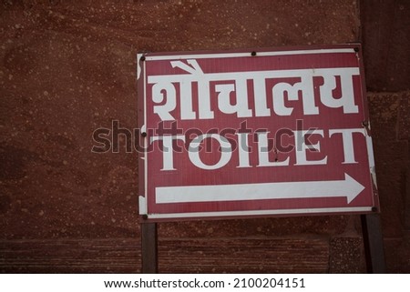 Toilet direction sign in Indian and English language