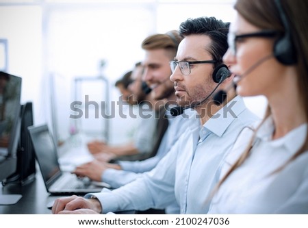 close up.background image of call center employees in the workplace Royalty-Free Stock Photo #2100247036