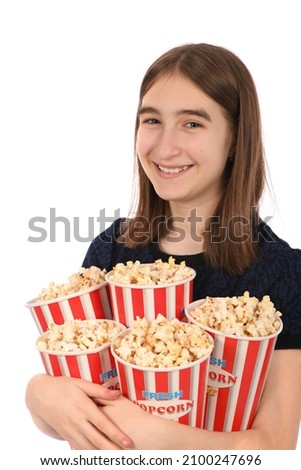 Portrait of a beautiful girl holding bucket of popcorn standing on white. High resolution photo.