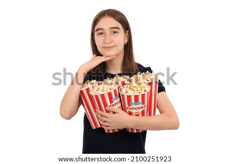Portrait of a beautiful girl holding bucket of popcorn standing on white. High resolution photo.