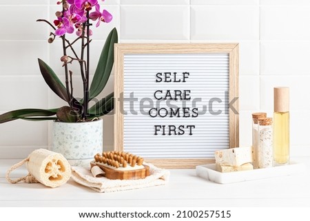Bathroom styling and organization. Letter board with text Self care comes first. Organic lifestyle and skin care products.  Royalty-Free Stock Photo #2100257515