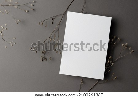 Wedding invitation card mockup with dry twigs on grey Royalty-Free Stock Photo #2100261367
