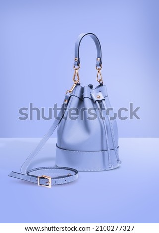 Fashion photography studio shot handbag isolated on a blue background