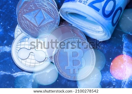 Horizontal view of cryptocurrency tokens, including Bitcoin, Ethererum Ripple, and Litecoin saw from above on Israeli Shekel ILS background. . High quality photo