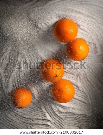 Five tangerines lying on semolina