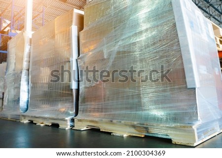 Packaging Boxes Wrapped Plastic Film on Pallets in Storage Warehouse. Supply Chain. Storehouse Commerce Shipment. Shipping Warehouse Logistics.