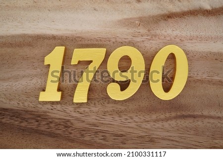 Golden Arabic numerals 1790 on a dark brown to white wood grain background.