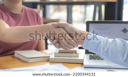 Business personage handshake, Asian women congratulate on being a corporate partnership with European male investors, Relationship of friendship, Sign language greetings, Business negotiation.