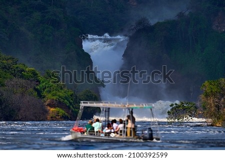 Uganda travel. Murchison Falls, waterfall between Lake Kyoga and Lake Albert on the Victoria Nile in Uganda. Africa river Landscape. Royalty-Free Stock Photo #2100392599