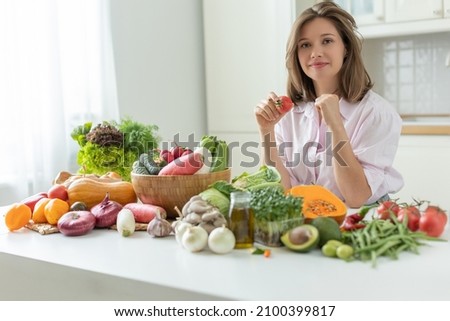 Woman in the kitchen with vegetables. High quality photo