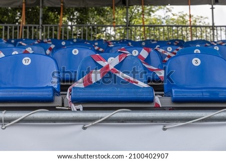 The Open air cinema with group of blue plastic chairs in summer day without people