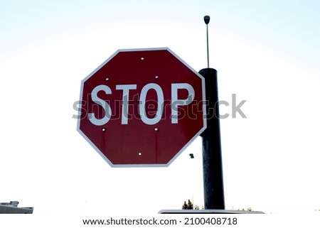 A closeup shot of a stop sign against a bright blurred background