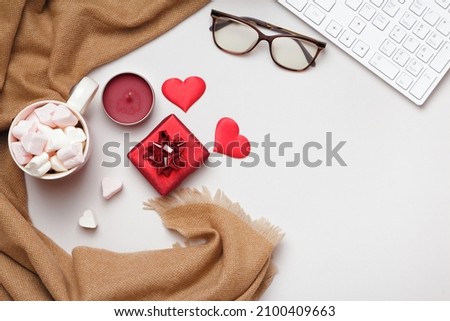 Desktop. Scarf glasses keyboard marshmallows valentine's day gift on gray table. Flat lay copy space