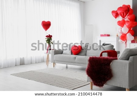 Interior of living room with sofa and decor for Valentine's Day Royalty-Free Stock Photo #2100414478