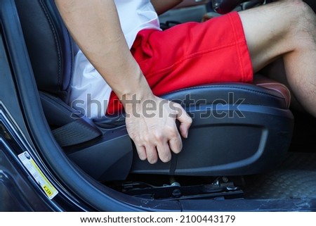 Lever handle for car seat height and low height adjustable.Hand holding on lever for Adjustable car seat Royalty-Free Stock Photo #2100443179