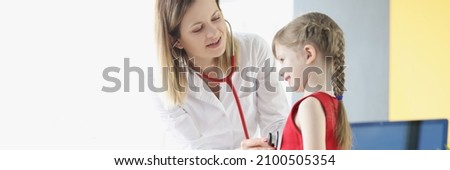 Pediatrician doctor listens to breathing and heartbeat with stethoscope of little girl. Medical services to children concept Royalty-Free Stock Photo #2100505354