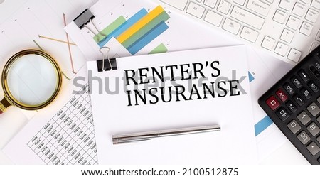 RENTER'S INSURANCE text on the white paper on light background with charts paper ,keyboard and calculator
