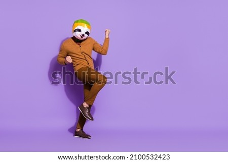 Full length portrait of weird unusual red panda mask person raise fists triumph isolated on violet color background