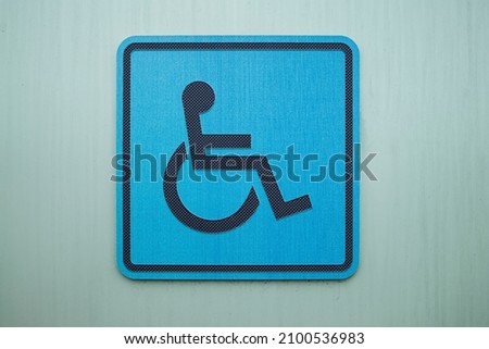 disabled person icon on wall . close up view 