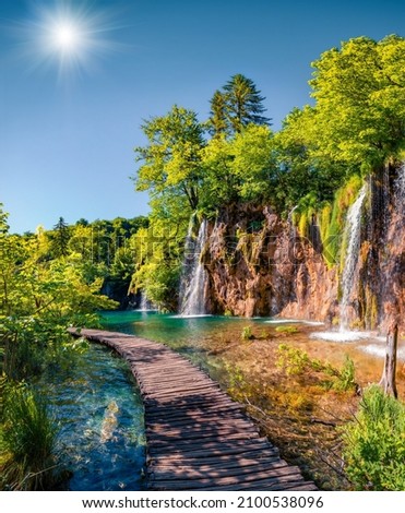 Picturesque summer view of green forest with pure water waterfall in Plitvice National Park. Sunny morning landscape of Croatia, Europe. Beauty of nature concept background. Royalty-Free Stock Photo #2100538096