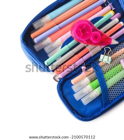 Opened pencil case with felt tip pens, corrector and paper clips on white background