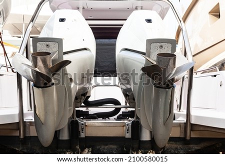 Motor propellers for motor yachts and boats close-up. The motors are installed at the stern of the boat. The outboard motors at the stern of the boat are raised. Royalty-Free Stock Photo #2100580015