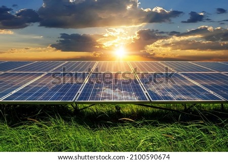 Photo collage of sunset and solar panel, photovoltaic, alternative electricity source - concept of sustainable resources Royalty-Free Stock Photo #2100590674