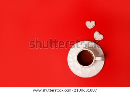 Valentine's red background concept with coffee cup and hearts