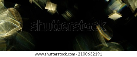 Easy to add lens flare effects for overlay designs or screen blending mode to make high-quality images. Abstract sun burst, iridescent glare over black background. Wide angle horizontal wallpaper.