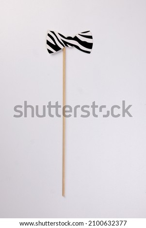 Black white bow tie shape paper die cut selfie portrait party fun paper prop sticker stick on white background