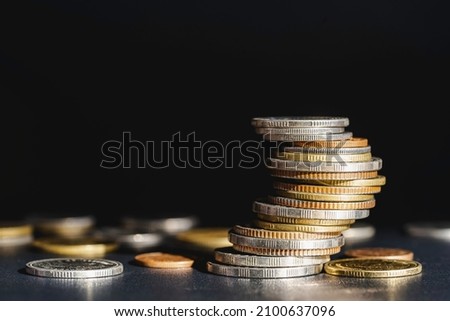 coins stacked on each other in different positions, Growth money of profitability of professional investment planning, Business, and finance concept.