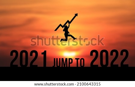 Siloouette business man jump to 2022