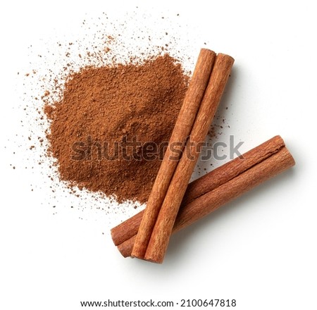 Cinnamon sticks and heap of powder isolated on white background, top view Royalty-Free Stock Photo #2100647818
