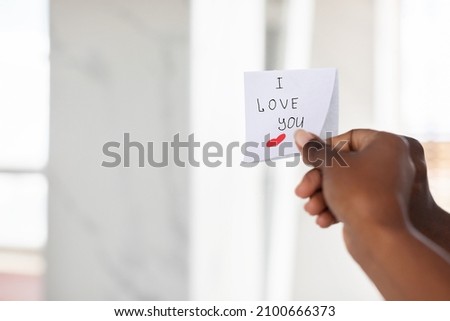 Black Female Hand Putting Sticky Note With Romantic Message On Mirror, Closeup Shot Of Unrecognizable African American Lady Sticking Paper With Handwritten I Love You Text And Drawn Heart, Cropped