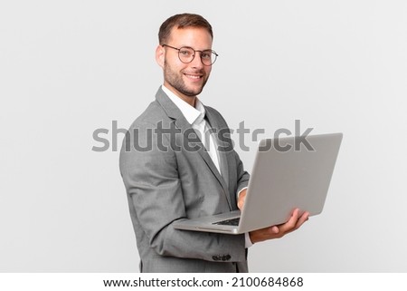 handsome businessman holding a laptop