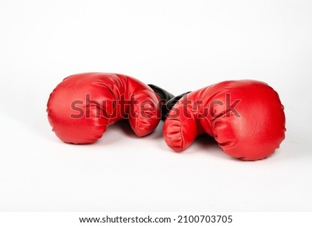  Red boxing gloves against white background.