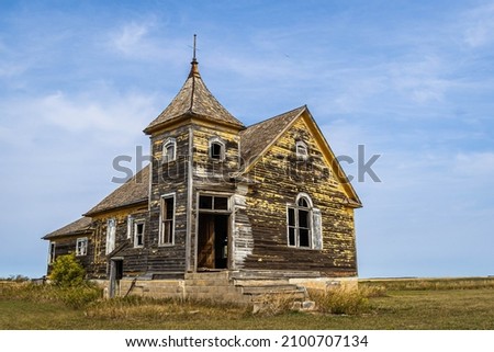 An old abandoned church on the prairie of North Dakota in the evening. Royalty-Free Stock Photo #2100707134
