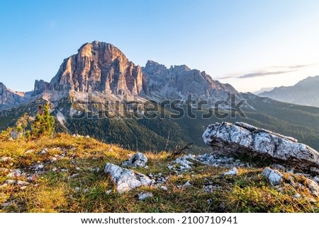 Sunrise morning view of Tofane mountains Tofana di Rozes from Rifugio Cinque Torri. Autumn landscape in Dolomites, Trentino Alto Adige region, South Tyrol, Italy, Europe. Royalty-Free Stock Photo #2100710941