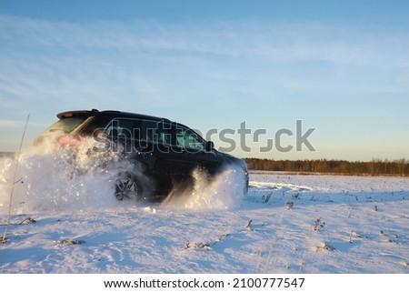 Car in the field winter. Off-road winter snow drifts. Extreme sport, entertainment. Royalty-Free Stock Photo #2100777547