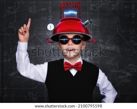 Smart child pretend to be inventor. Funny kid wearing helmet . Education, artificial intelligence and business idea concept Royalty-Free Stock Photo #2100795598