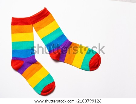 a pair of rainbow colorful socks at white background Royalty-Free Stock Photo #2100799126