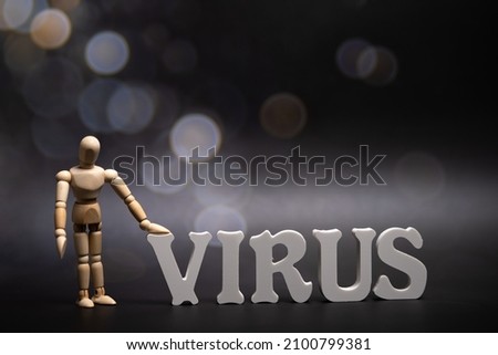 the word Virus at dark background with bokeh. Omikron is the new type of corona virus from South Africa, marked as B.1.1.529 Royalty-Free Stock Photo #2100799381