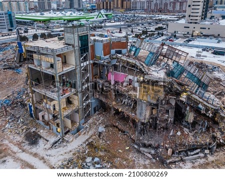 Demolition of the mall. Renovation in Russia. Destruction of building structures. Drone view. Pile of rubble from a dismantled building 