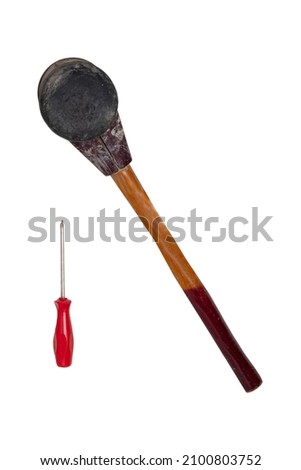 Size comparison between a professional paving hammer and a screwdriver isolated on a white background. A bricklayers equipment for laying paving stones. Craftsman tools.