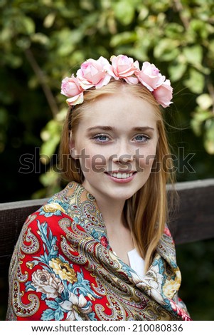 Russian beauty woman in the national patterned scarf