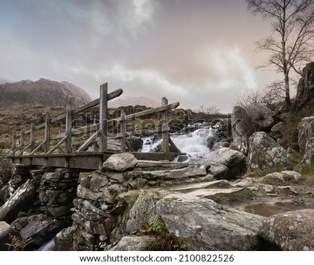 Wooden bridge over a waterfall and stream in The Ogwen Valley in Snowdonia National Park, North Wales